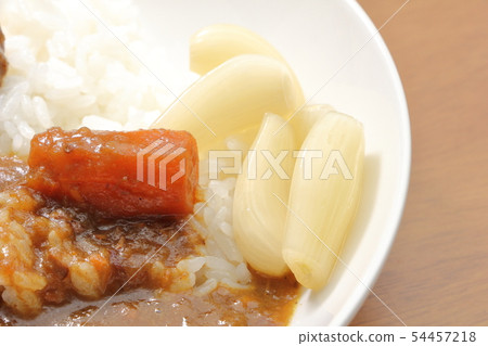 Curry rice garnished with sweet and sour pickled raccoon. 54457218