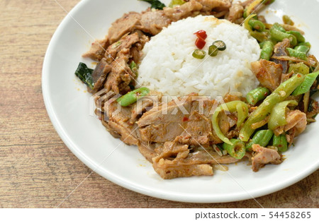 spicy stir fried duck meat curry on rice in plate 54458265