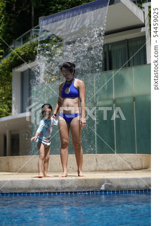 Asian chinese child hesitant to enter water 54459025