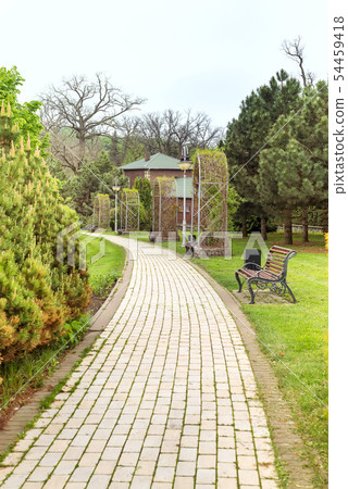 The path in the park with a lot of places to relax. Autumn time The path in the park with a lot of places to relax. Autumn time 54459418