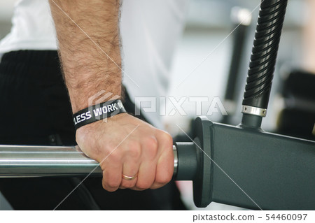 Close up view of man's hand until work out in the gym Close up view of man's hand until work out in the gym 54460097