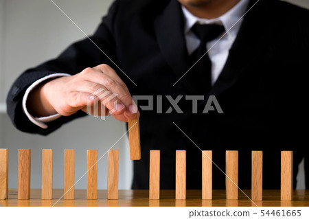 Businessmen picking dominoes to fill the missing. 54461665