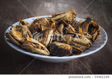 Fried fish heads for a simple meal of rural people Fried fish heads for a simple meal of rural people 54462289