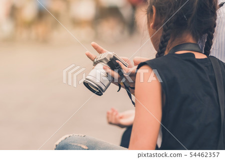 Mom teaches her daughter to taking pictures. 54462357