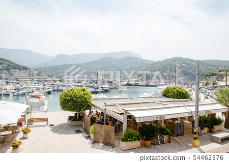 A view from the top of the hill with a harbor with yacht harbors in Soller, Majorca, and distant mountains A view from the top of the hill with a harbor with yacht harbors in Soller, Majorca, and distant mountains 54462576