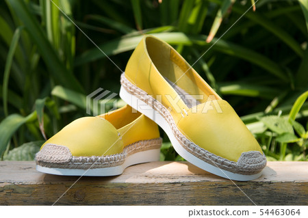 Espadrilles on a background of green grass. Espadrilles on a background of green grass. 54463064