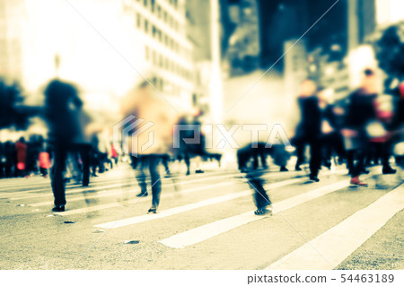 Blurred image of people moving on crosswalk Blurred image of people moving on crosswalk 54463189