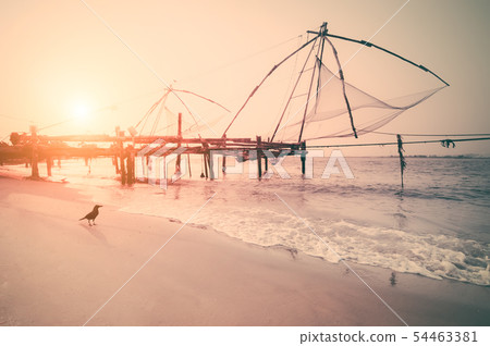 Fishing nets silhouette at sunset. Cochin, India Fishing nets silhouette at sunset. Cochin, India 54463381