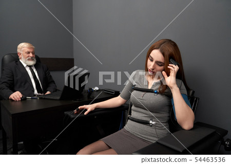 Woman answering questions during lie detector test Woman answering questions during lie detector test 54463536