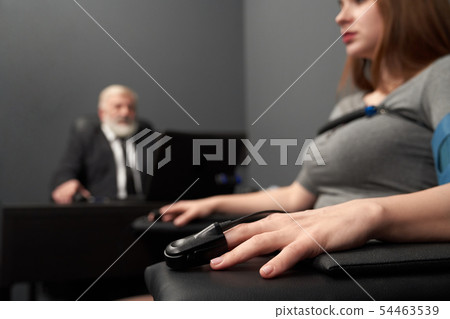 Female hand with indicator for measuring pulse on truth test 54463539