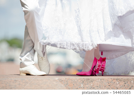 Feet of the bride and groom in shoes Feet of the bride and groom in shoes 54465085
