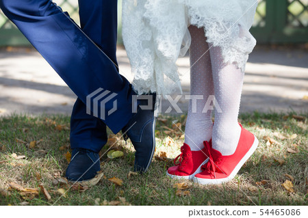 Feet of the bride and groom in shoes 54465086
