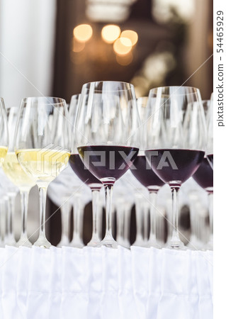 Rows of red and white wine glasses on white Rows of red and white wine glasses on white 54465929