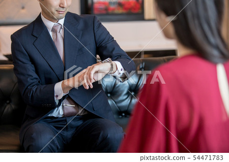 Businessman who cares about watch Businessman who cares about watch 54471783