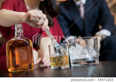 Woman making a drink Woman making a drink 54471883
