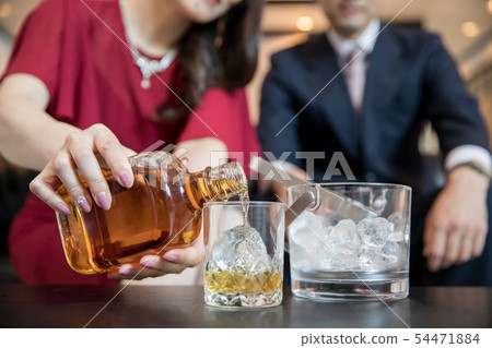 Woman making a drink 54471884
