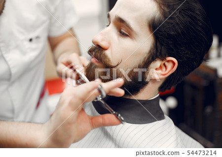 Stylish man sitting in a barbershop Stylish man sitting in a barbershop 54473214