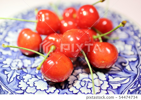 Served cherries on a plate 54474734