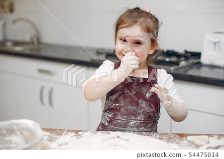 Little girl cook the dough for cookies Little girl cook the dough for cookies 54475014