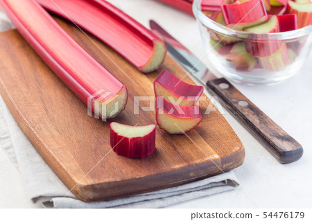 Cutted rhubarb on  wooden board, horizontal 54476179