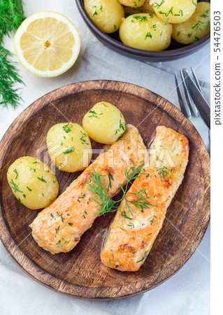 Baked salmon in creamy sauce with young potato Baked salmon in creamy sauce with young potato 54476503