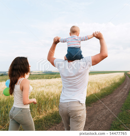Happy young family enjoy time together outdoors Happy young family enjoy time together outdoors 54477765