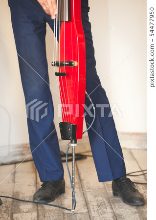 Man plays electric double bass Man plays electric double bass 54477950