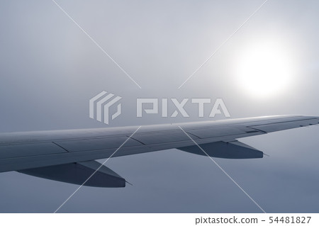 airplane wing silhouette with blue sky horizon 54481827