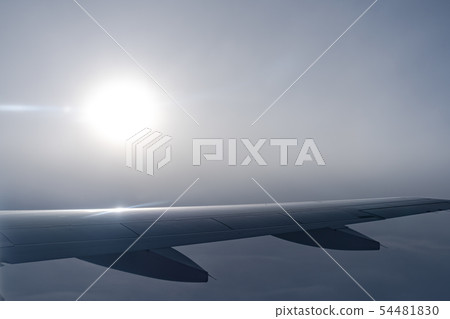 airplane wing silhouette with blue sky horizon 54481830