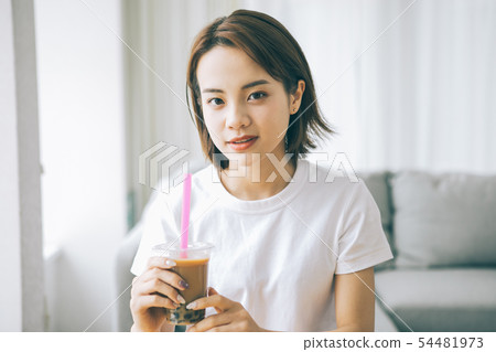 Young woman drinking tapioca milk tea Young woman drinking tapioca milk tea 54481973