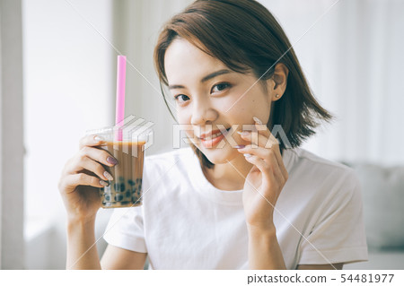 Young woman drinking tapioca milk tea 54481977