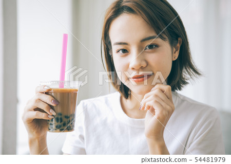 Young woman drinking tapioca milk tea Young woman drinking tapioca milk tea 54481979