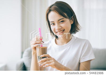 Young woman drinking tapioca milk tea Young woman drinking tapioca milk tea 54481986