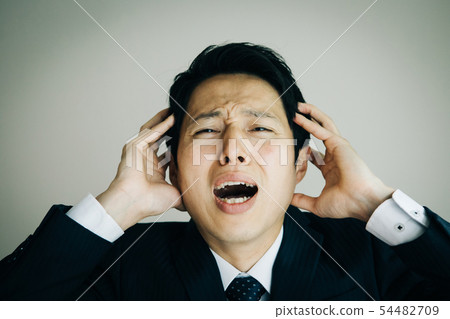Businessman holding a head Japanese male trouble shock 54482709