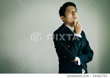 Business man thinking Japanese men trouble distress 54482752