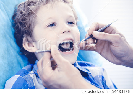 Doctor and patient child. Boy having his teeth examined with dentist. Medicine, health care and Doctor and patient child. Boy having his teeth examined with dentist. Medicine, health care and 54483126