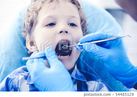 Doctor and patient child. Boy having his teeth examined with dentist. Medicine, health care and 54483129
