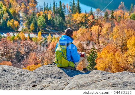 Backpacker man at Artist's Bluff in autumn 54483135