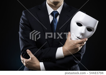 A man wearing a mask and a suit 54483794