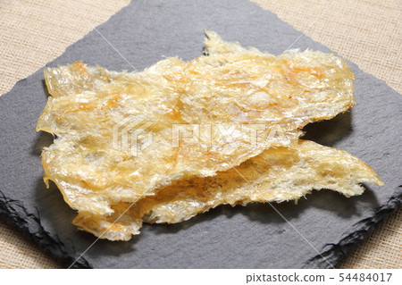 A snack and grilled on a slate plate. 54484017