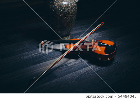 Twilight: bow and violin lying on the floor next Twilight: bow and violin lying on the floor next 54484043