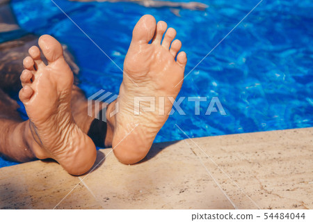 Stay at the resort. Men's legs on a large water Stay at the resort. Men's legs on a large water 54484044