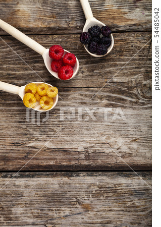 Ripe raspberry on an old wooden table. 54485042