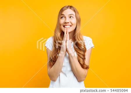focused girl asks God to help her, holding hands 54485094