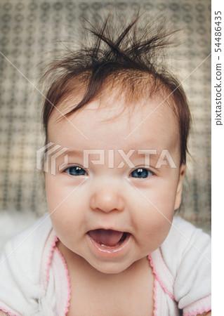 portrait of a little girl: baby's face close-up 54486435