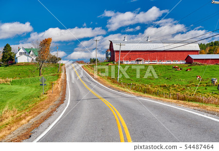 Highway and red barn at sunny autumn day Highway and red barn at sunny autumn day 54487464