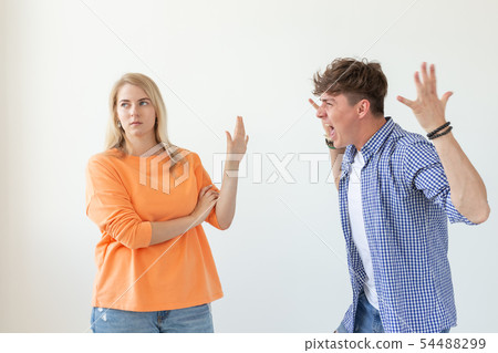 Young hipster guy shouts raising his hands up to his beloved girl showing by hands stop on a white Young hipster guy shouts raising his hands up to his beloved girl showing by hands stop on a white 54488299