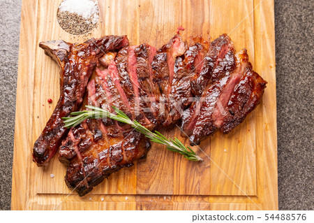 Food, delicious, horse meat and craft concept - serving of grilled steak Food, delicious, horse meat and craft concept - serving of grilled steak 54488576