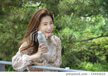 Woman drinking water Woman drinking water 54493620