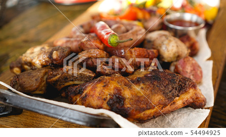 Mixed grilled meat platter. Assorted delicious grilled meat with vegetable. 54494925